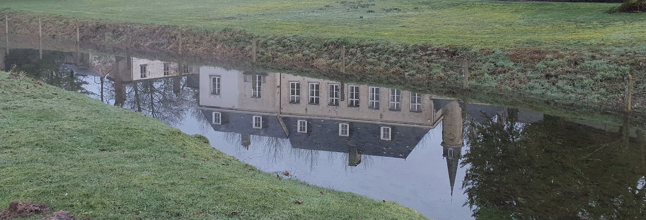 Sauliniere castle moat with a reflection on the castle